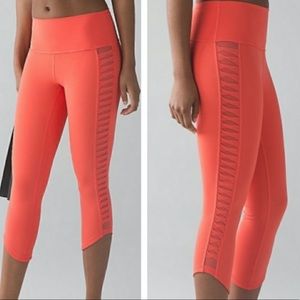 Lululemon cropped orange leggings with mesh detailing on sides